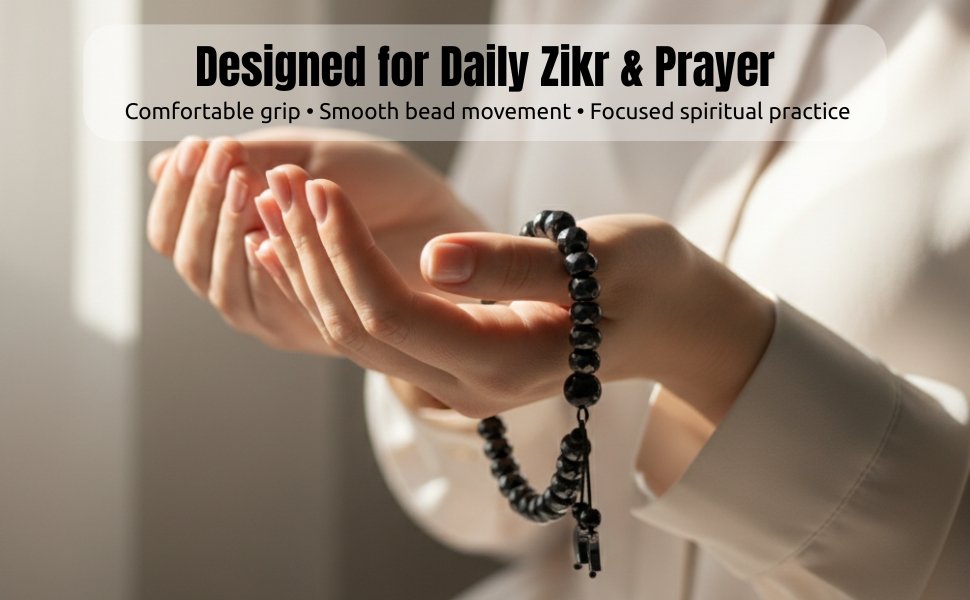 Close up view of hands in prayer holding the hematite 33-bead misbaha bracelet
