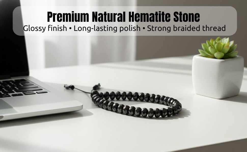 Reflective black hematite bracelet set elegantly on a workspace desk next to a white laptop