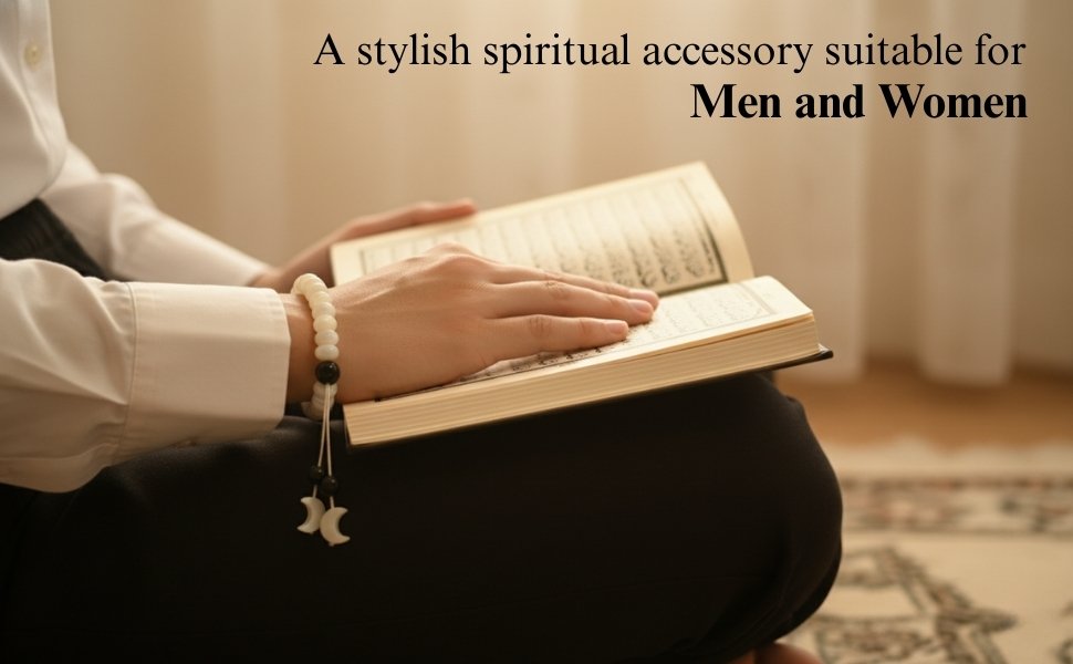 Unisex lifestyle view of a practitioner wearing the pearl tasbih bracelet while reading an open book