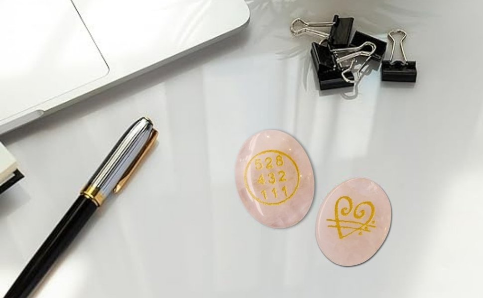 Rose Quartz stones styled on a professional office desk with a pen and laptop